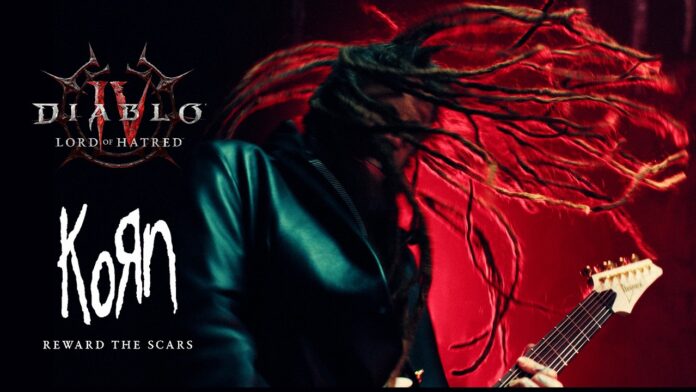 Korn: Neue Single „Reward The Scars“ für Diablo IV: Lord Of Hatred Album cover showing KoRn's 'Reward the Scar' logo with a guitarist's vivid red background and long dreadlocks in motion, for promotional art.