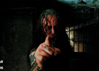 Man with long hair and tattoos points at the camera in a dark, grimy basement; Nuclear Blast Records logo appears in the bottom-left corner.