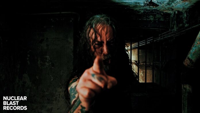 Benediction kündigt Besetzungswechsel an Man with long hair and tattoos points at the camera in a dark, grimy basement; Nuclear Blast Records logo appears in the bottom-left corner.