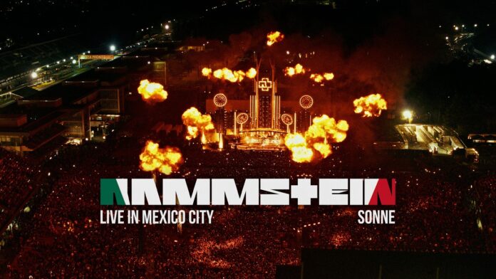 Rammstein veröffentlichen „Sonne (Live in Mexico City)“ Overhead view of a nighttime stadium concert with intense flames bursting from the stage and a packed crowd.